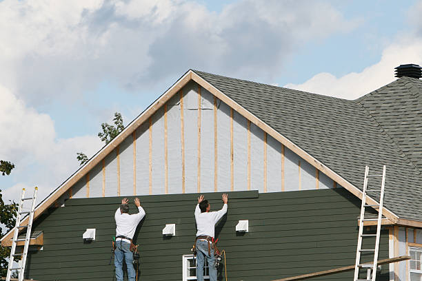Professional Siding technician working in East Walpole, MA